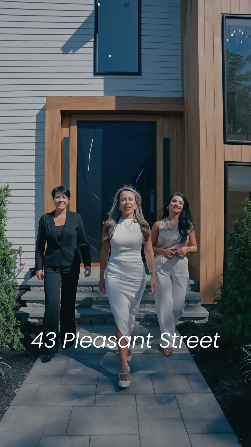 Be Live In Realty agents at a front door.